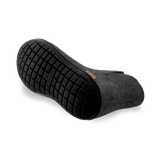 Bottom view of a Black wool boot with a black rubber sole.