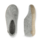 Pair of gray slippers with a beige sole on a white background
