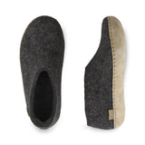 Pair of gray slippers with a leather sole on a white background