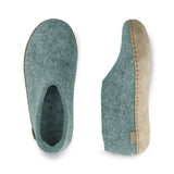 Pair of north sea slippers with leather soles on a white background