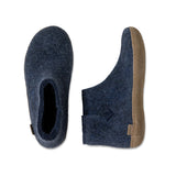 Pair of blue slippers with brown soles on a white background