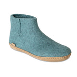 Teal ankle boot with brown sole on a white background