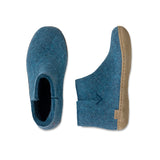 Pair of blue slippers with a beige sole on a white background
