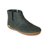 Green ankle boot with  honey rubber sole on a white background
