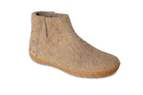 Brown ankle boot with a honey rubber  sole on a white background