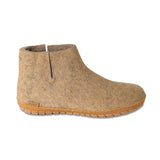 Brown ankle boot with a honey rubber  sole on a white background