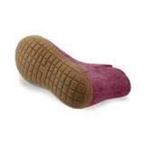 Bottom view of a cranberry wool boot with a natural rubber sole.