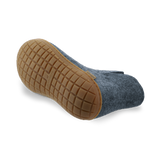 Bottom view of a Denim wool boot with a natural rubber sole.