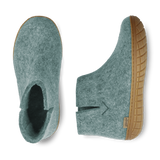 Side view and top view of a North Sea wool boot with a natural rubber sole on a white background.