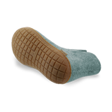 Bottom view of a north sea wool boot with a natural rubber sole on a white background.