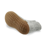 Bottom view of a Grey wool boot with a natural rubber sole.