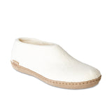 White slipper with brown sole on a white background