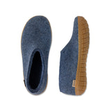 Pair of blue slippers with honey rubber soles on a white background