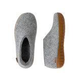 Gray felt slippers with honey rubber soles on a white background