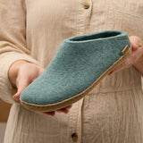 Person holding a north sea slipper with a leather sole