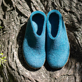 Pair of blue slippers on a tree trunk