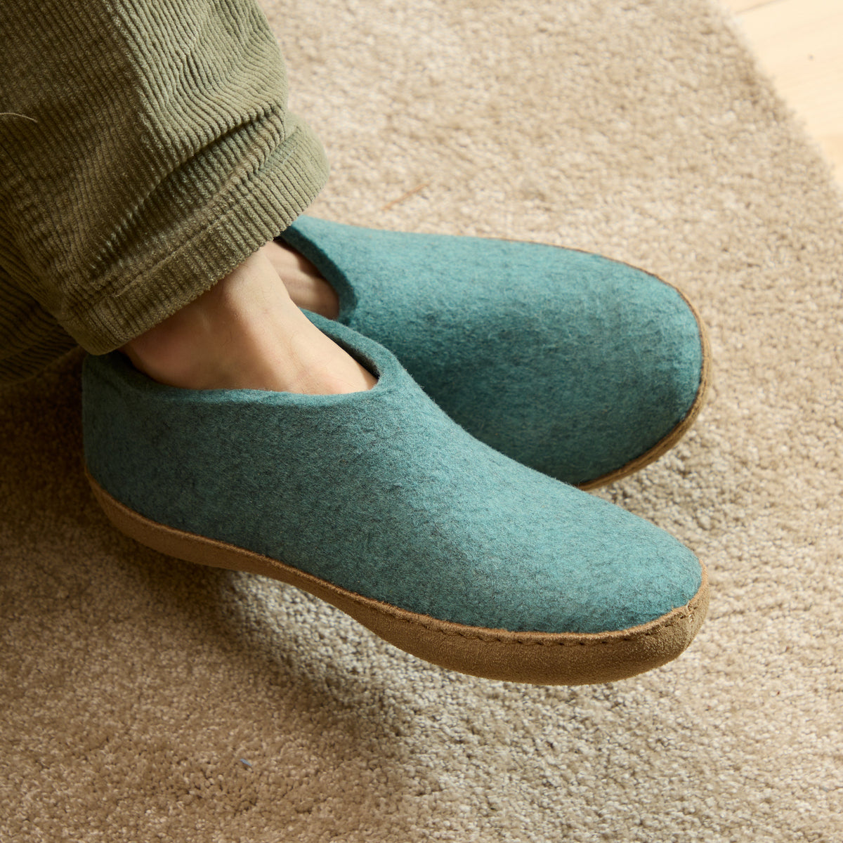 North Sea slippers worn indoors on a carpeted floor